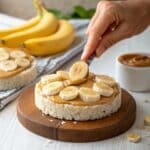 Peanut Butter and Banana Rice Cakes – The Healthy Snack You’ll Crave Daily 5 peanut butter and banana rice cakes being assembled