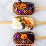 Halloween Cakesicles – Fun & Spooky Chocolate Covered Treats 8 halloween cakesicles decorated as pumpkins