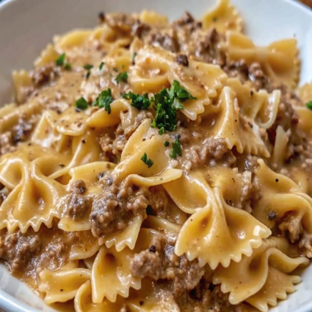 serving creamy parmesan garlic beef bowtie pasta