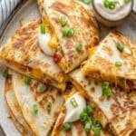 Easy Chicken Quesadillas sliced with melted cheese and salsa