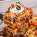 Easy Mexican Lasagna slice with tortillas, beef, beans, and cheese