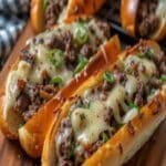 Ground Beef Philly Cheesesteaks on toasted rolls with melted cheese
