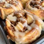 Apple Pie Cinnamon Rolls – Irresistibly Soft, Gooey, and Perfect for Cozy Fall Baking 5 Freshly baked apple pie cinnamon rolls drizzled with icing and filled with spiced apples.