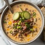 Keto Cheeseburger Soup in rustic bowl with bacon and cheese topping