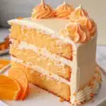 Orange Creamsicle Cake: Soft, Creamy, and Bursting with Citrus Orange Creamsicle Cake slice of orange creamsicle cake with creamy frosting