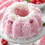 Raspberry Coconut Snowball Cake: Fluffy Coconut Layers with Bright Raspberry Raspberry Coconut Snowball Cake Raspberry Coconut Snowball Cake with coconut coating