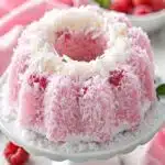 Raspberry Coconut Snowball Cake: Fluffy Coconut Layers with Bright Raspberry Raspberry Coconut Snowball Cake Raspberry Coconut Snowball Cake with coconut coating