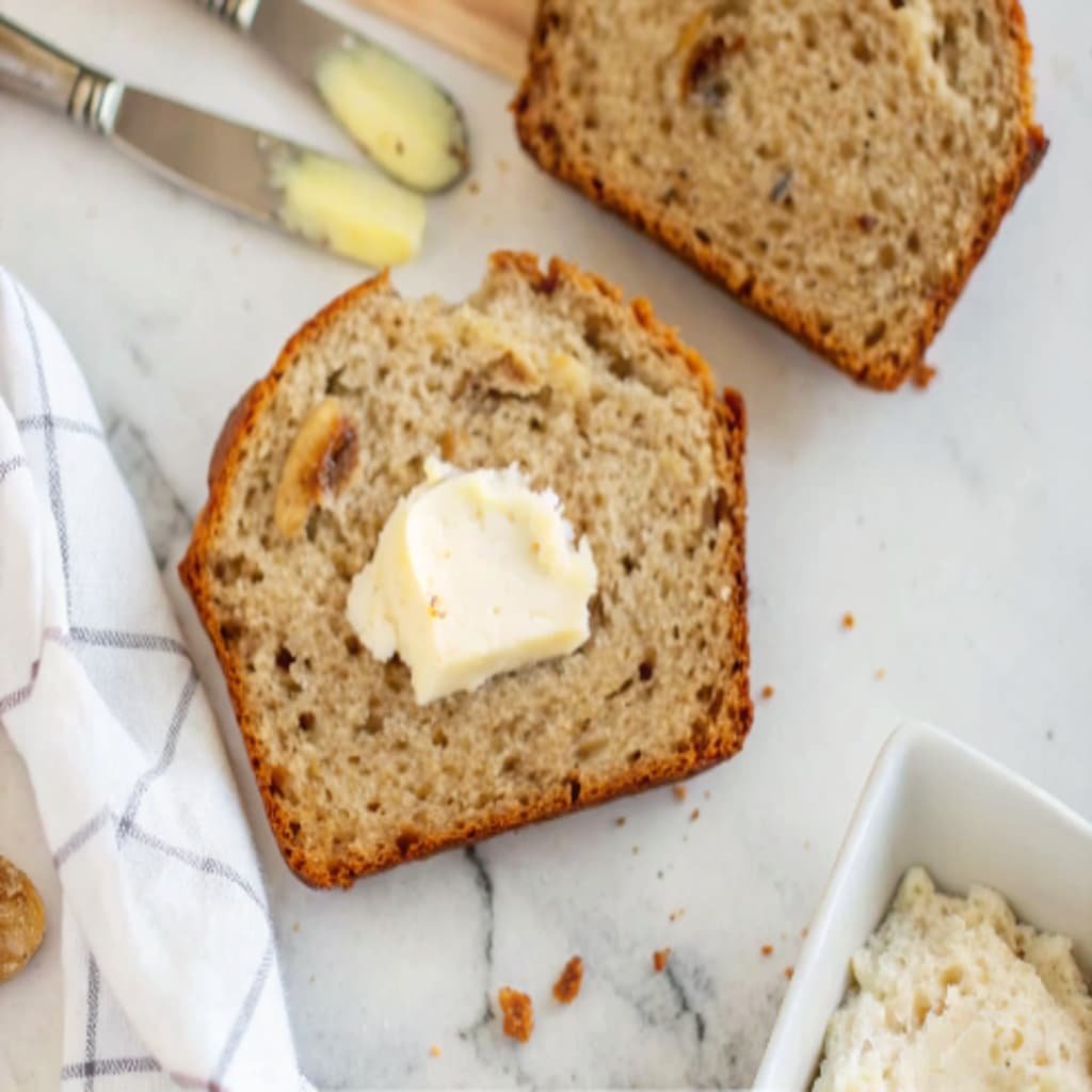 slice of sourdough discard banana bread with butter