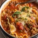 Cozy crockpot lasagna soup in bowl with cheese toppings